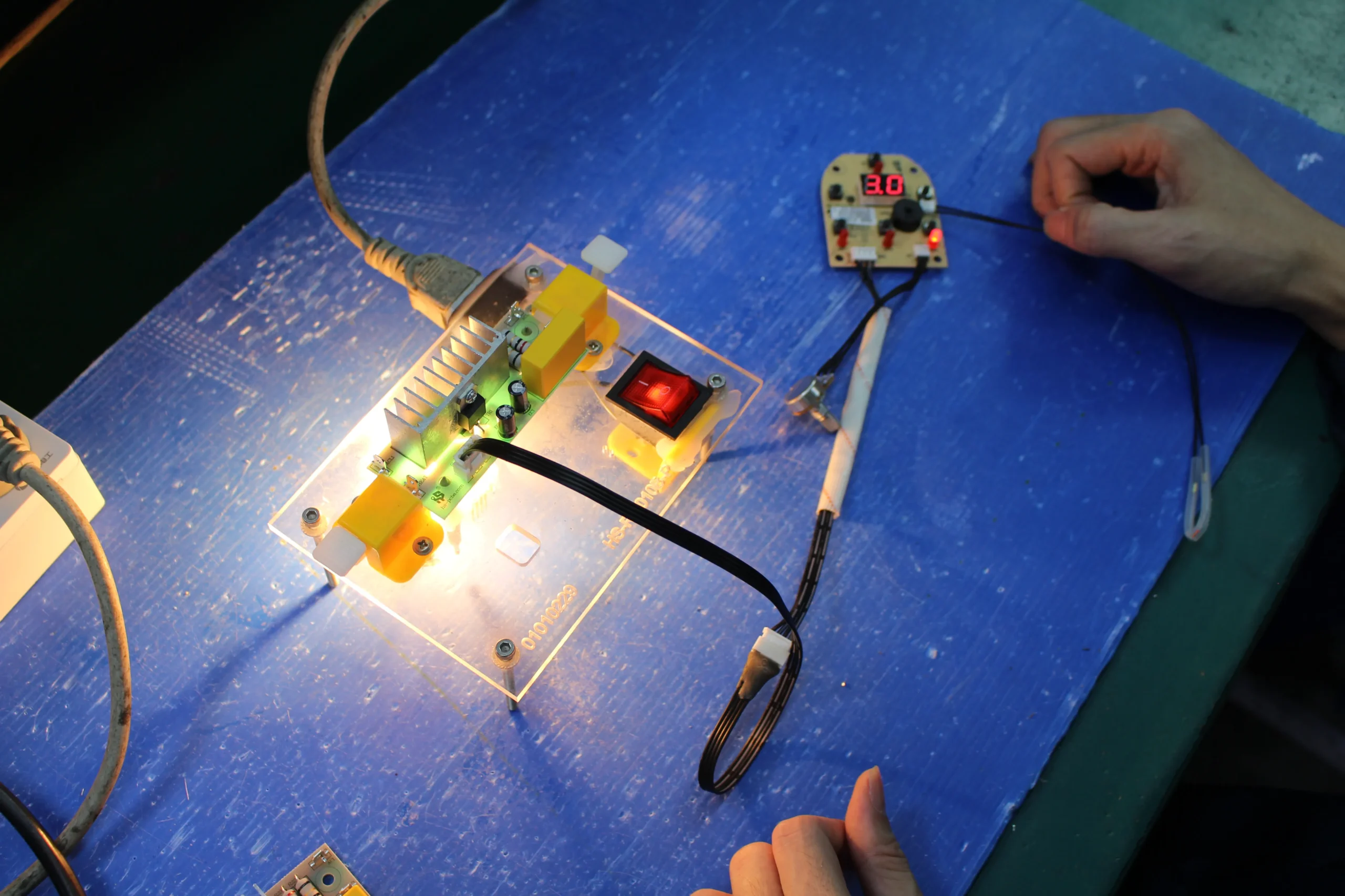 PCBA board in an ICT pogo-pin test fixture with bench testers