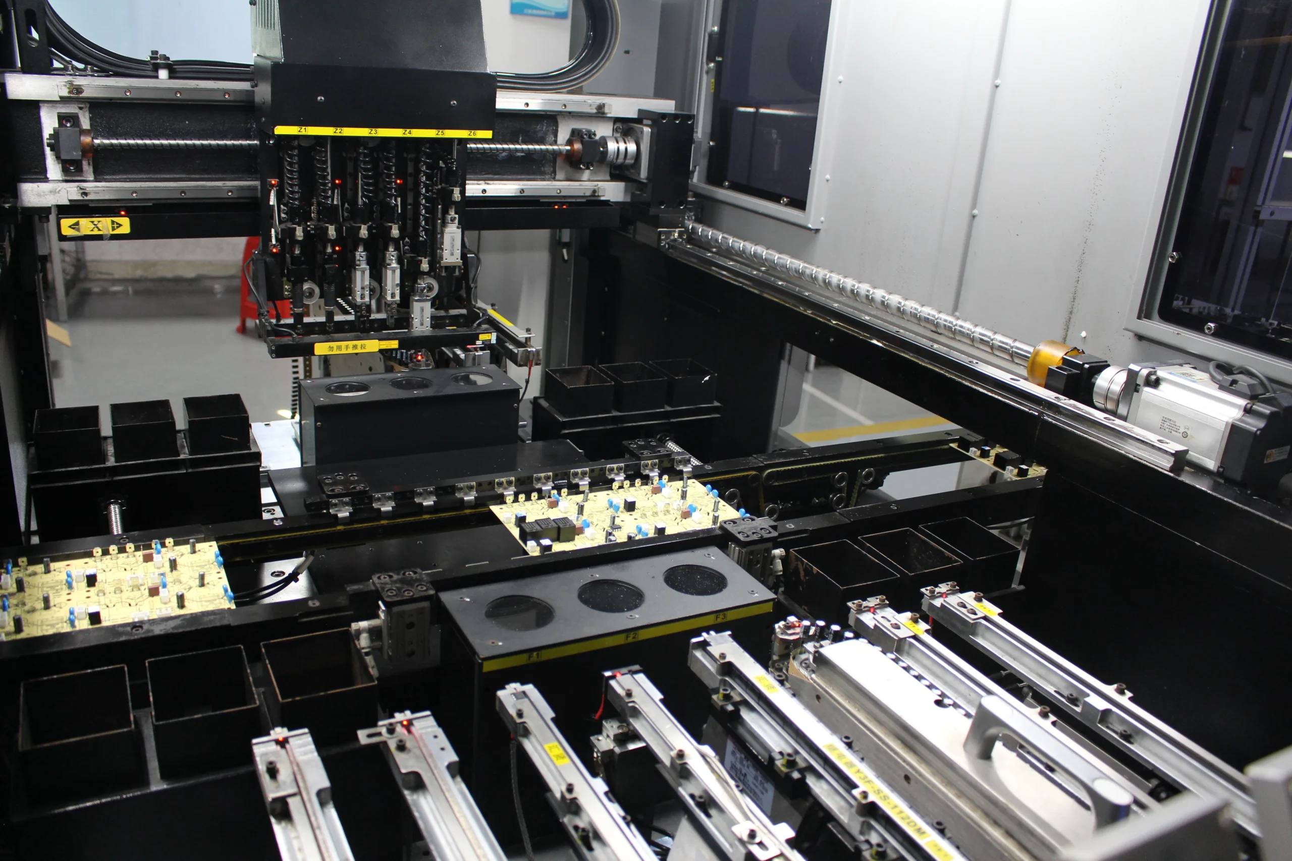 Technician inspecting an assembled PCBA at a pilot production line